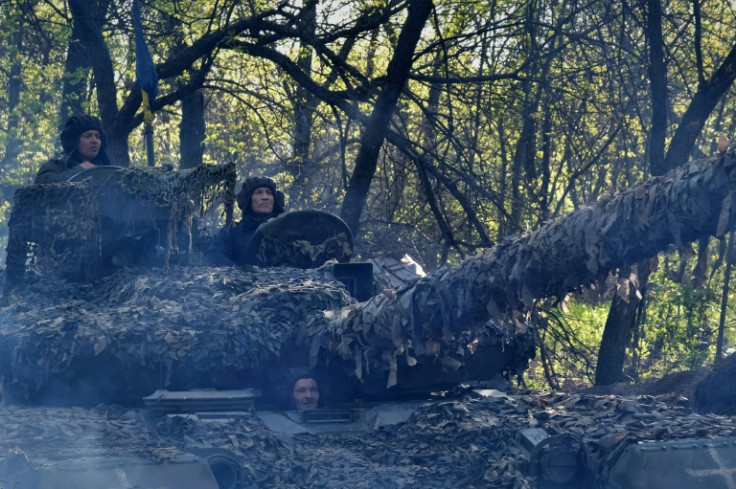 Ukrainian troops in a T-64 tank head toward a front line near the town of Bakhmut on May 7, 2023