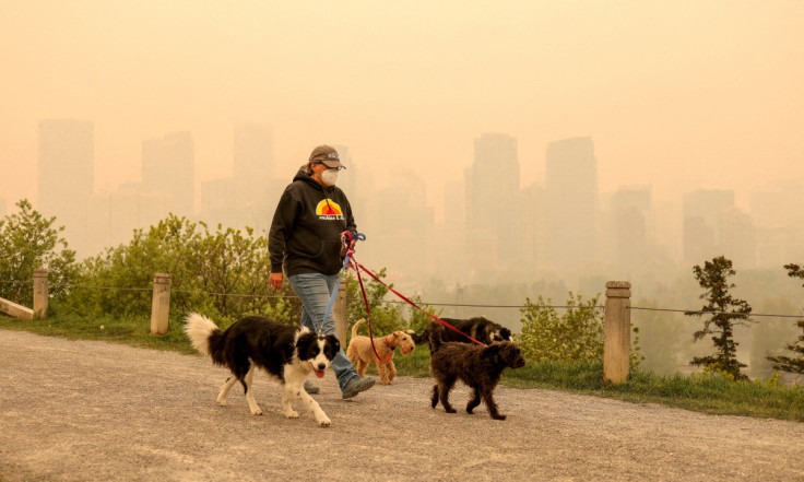 Smoke from some of the 90 wildfires active in the province hangs in downtown Calgary