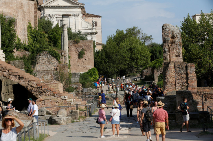Tourists walk along the Roman Forum