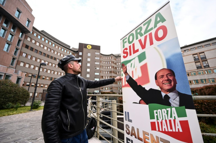 A banner reading "Go Silvio!" in front of San Raffaele hospital