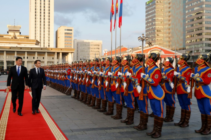 Mongolia's President Ukhnaagiin Khürelsukh and France's Emmanuel Macron inspect a guard of honour