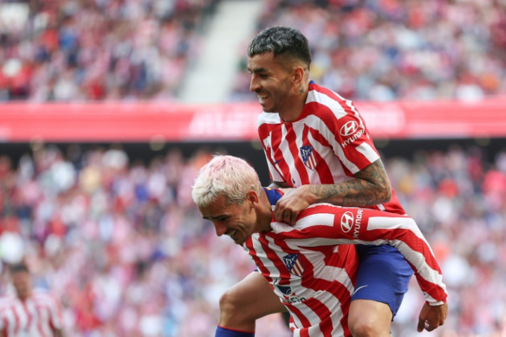 Atletico Madrid forward Angel Correa (top) celebrates with Antoine Griezmann after scoring his team's third goal against Osasuna