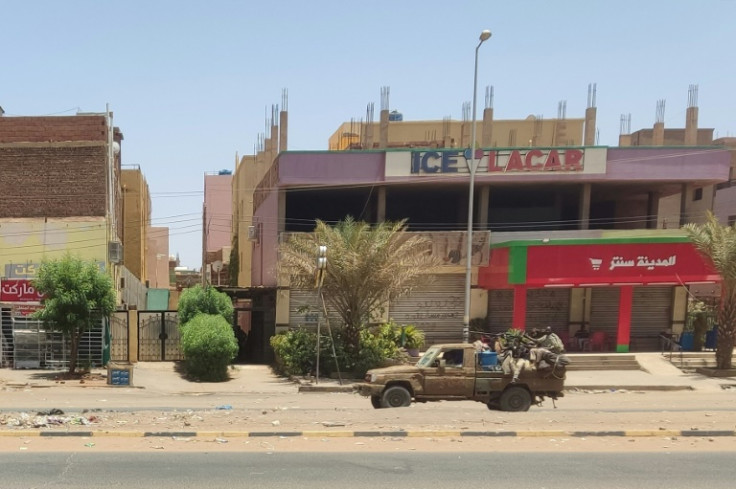 An RSF vehicle drives down a main road in Khartoum
