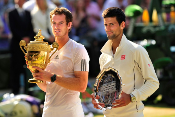 At last: Andy Murray poses with the winner's trophy next to runner-up Novak Djokovic after winning the 2013 Wimbledon title