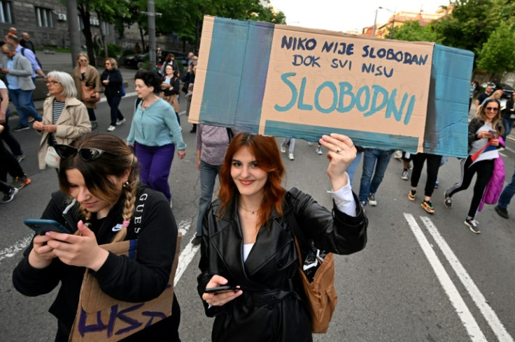 'No one is free until all are free' says a placard held up at a May 19 protest
