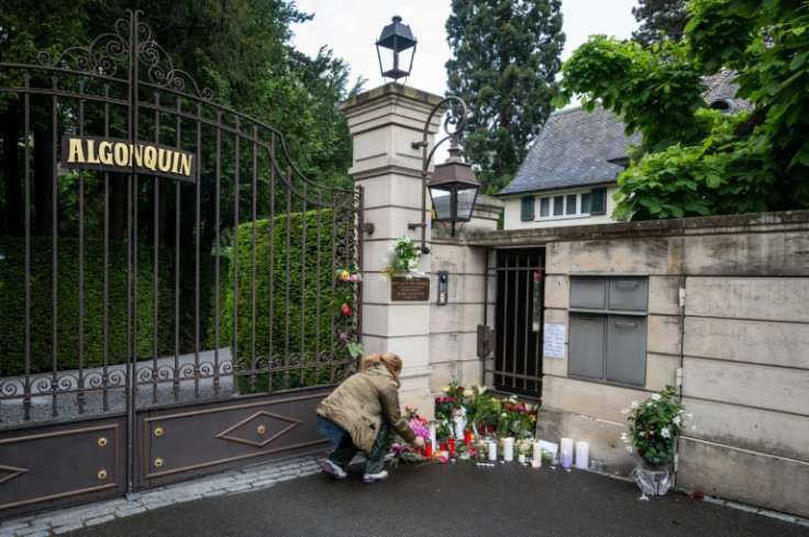 A mourner lays flowers outside the Swiss chateau of late singer Tina Turner