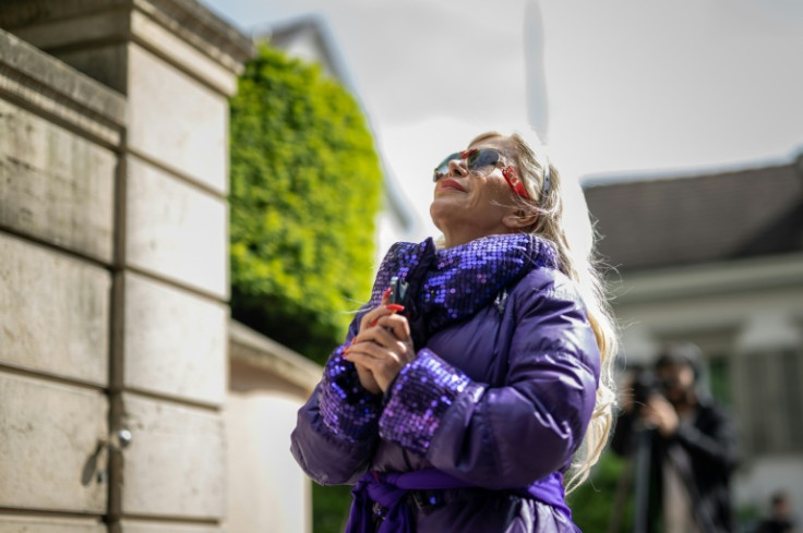 A fan prays outside Tina Turner's Swiss home