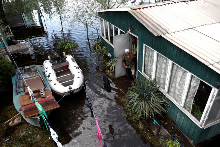 Mykola leaves a house on a flooded island which locals and officials say is caused by Russia's chaotic control of the Kakhovka dam downstream near Zaporizhzhia