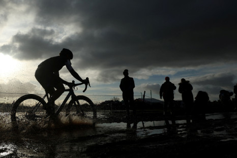 A competitor cycles through a puddle during the Senior Women's race at the British Cyclocross championships near Milnthorpe