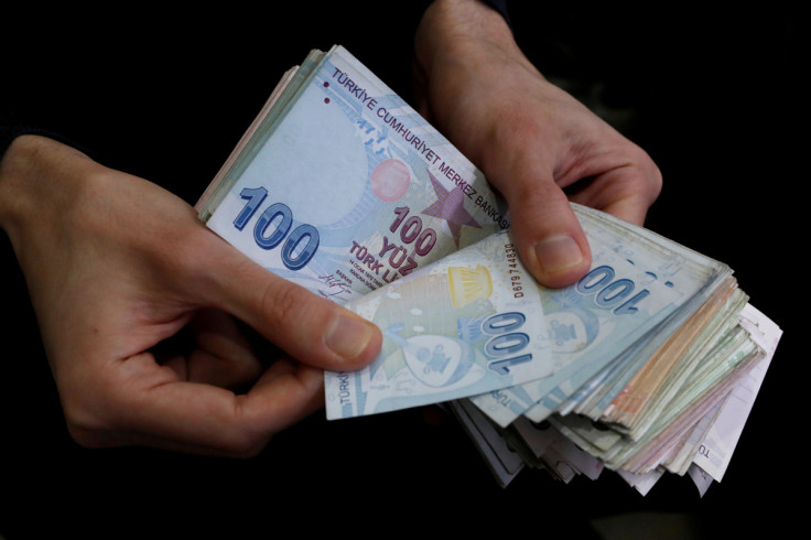 A merchant counts Turkish lira banknotes at the Grand Bazaar in Istanbul, Turkey