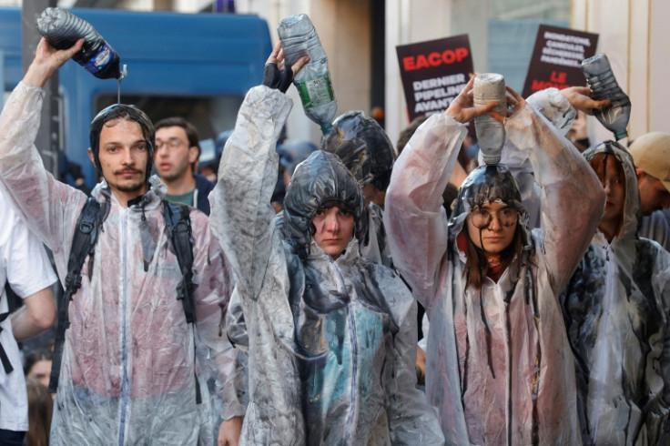 Climate protesters pour oil-like liquid over themselves outside TotalEnergies' AGM, May 2023