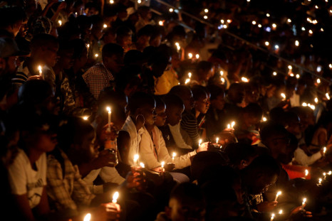 Participants hold candles while holding a night vigil during a commemoration ceremony marking the 25th anniversary of the Rwandan genocide, at the Amahoro stadium in Kigali