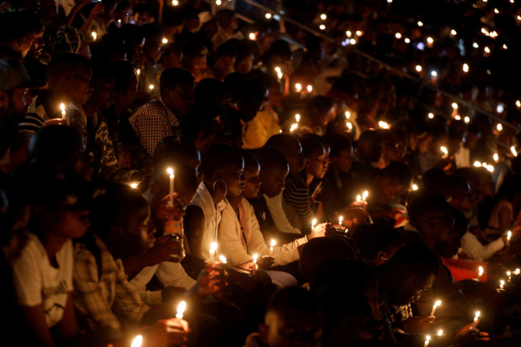 Participants hold candles while holding a night vigil during a commemoration ceremony marking the 25th anniversary of the Rwandan genocide, at the Amahoro stadium in Kigali