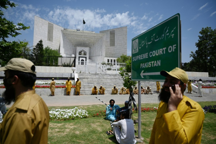 Supporters of parties of Pakistan's ruling alliance gather outside the Supreme Court to protest against the judiciary