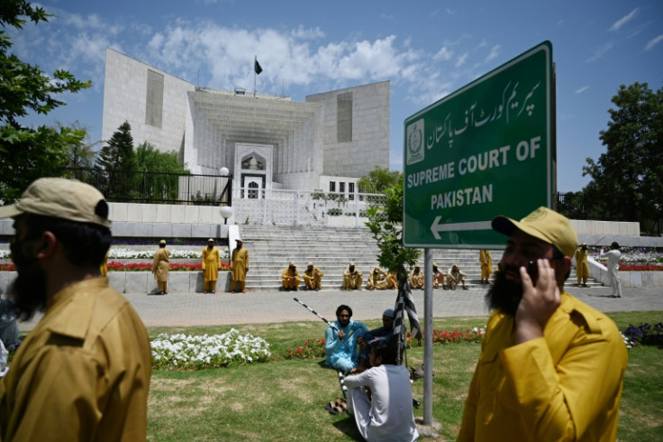 Supporters of parties of Pakistan's ruling alliance gather outside the Supreme Court to protest against the judiciary