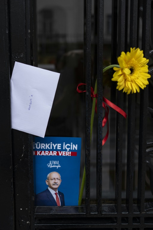 Opposition supporters pin letters and campaign posters to their neighbours' doors to rally turnout