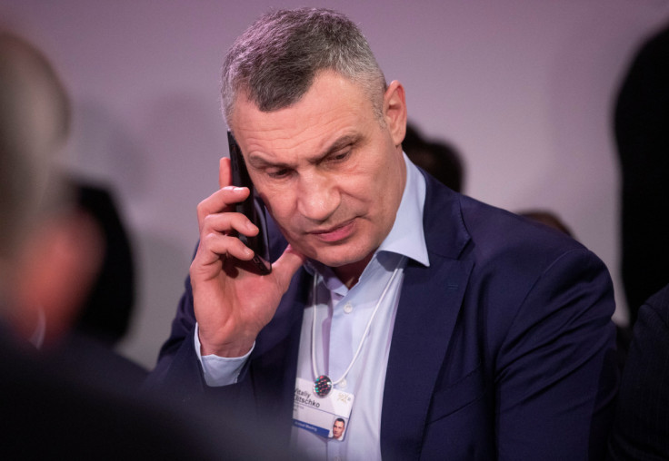 Mayor of Kyiv Vitali Klitschko uses a mobile phone ahead of a meeting in the World Economic Forum in Davos