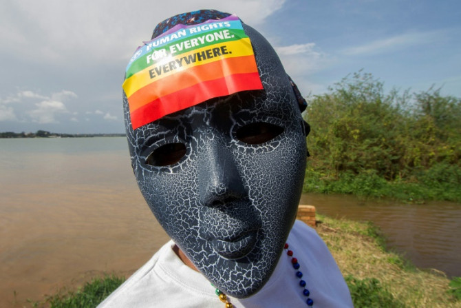 A Ugandan wearing a mask with a rainbow sticker takes part in the Gay Pride parade in Entebbe in 2015