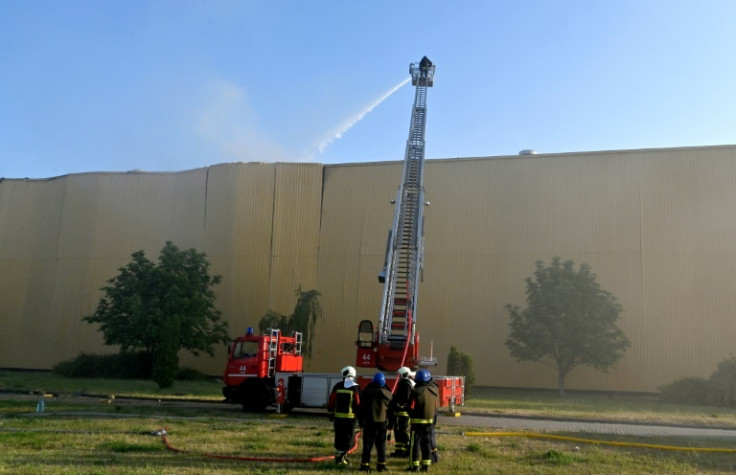 Rescuers put out a fire at an industrial facility after a massive Russian drone strike on the capital Kyiv overnight Saturday-Sunday