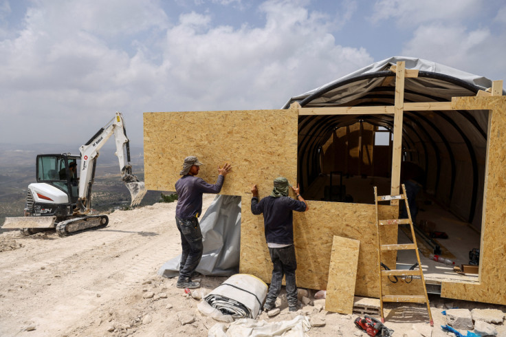 Israeli settlers erect structures for a new Jewish seminary school, in the settler outpost of Homesh in the Israeli-occupied West Bank