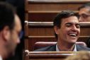 Former leader of PSOE Sanchez laughs in front of Socialists parliamentarian spokesman Hernando during the investiture debate at Parliament in Madrid
