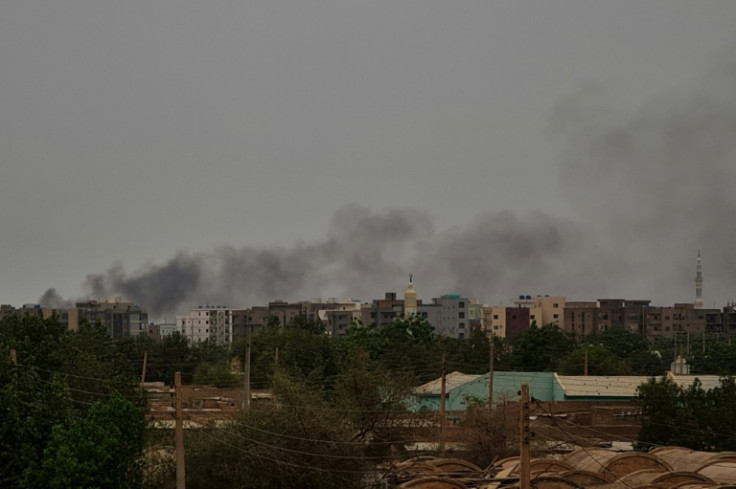 Smoke billows behind buildings in Khartoum as fighting between the army and paramilitaries continues despite a ceasefire they signed
