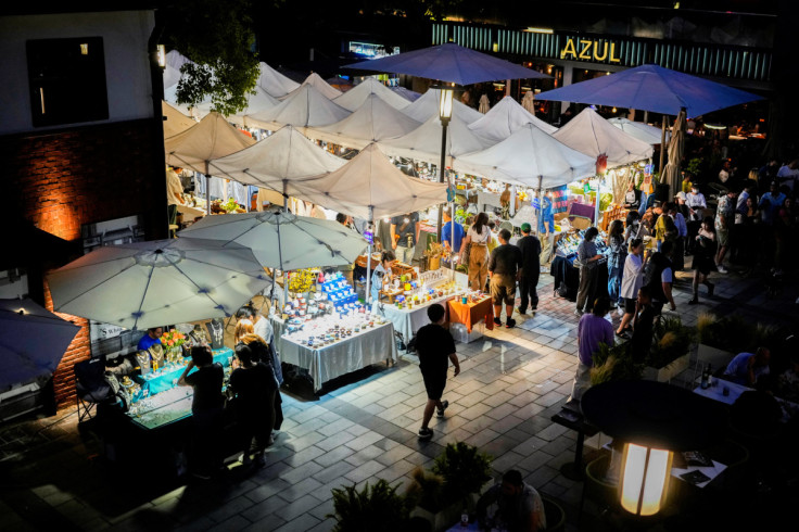 People visit a market on a street in Shanghai