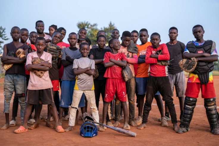 Many of the other kids scrambling about the dirt diamond in Gayaza are also orphans raised in poverty, says volunteer coach John Bosco Sempa