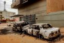 Destroyed vehicles are pictured outside the burnt down headquarters of Sudan's Central Bureau of Statistics in the south of Khartoum on May 29, 2023