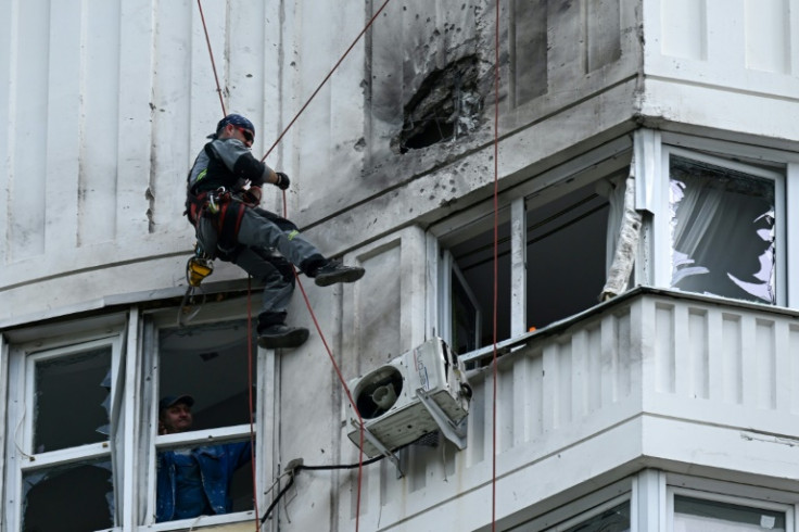 A specialist inspects the facade of a multi-storey Moscow apartment block damaged in a reported drone attack