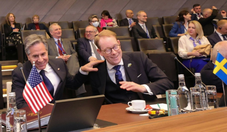 US Secretary of State Antony Blinken and  Sweden's Foreign Minister Tobias Billstroem share a laugh at the start of a NATO meeting in Brussels on April 4, 2023