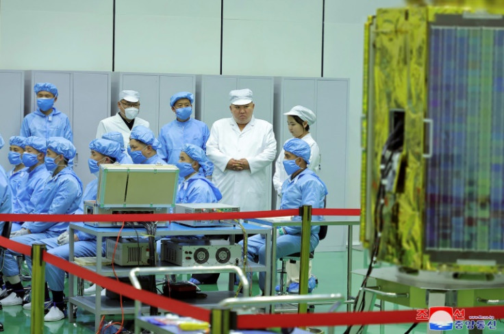 North Korean leader Kim Jong Un (top, 2nd R) has identified the development of reconnaissance satellites as a key defence project