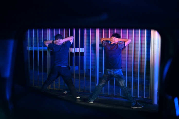 Suspects wait to be frisked during a police operation in El Salvador, where 69,000 suspected gangsters have been arrested in the last 14 months