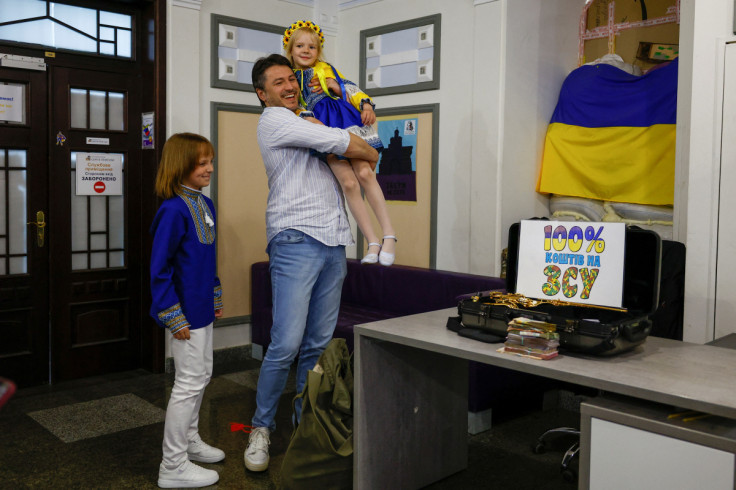 Fundraiser Prytula greets Mariia and Oleksandr who donated money for his foundation in Kyiv