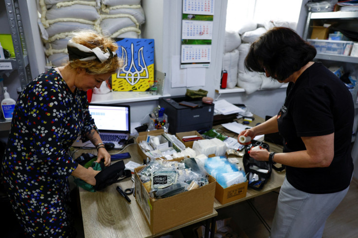 Volunteers prepare individual first aid kits for Ukrainian service members at the office of Prytula's charity foundation in Kyiv