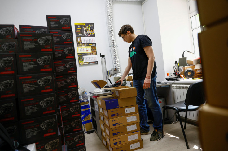 A volunteer prepares mobile radios for Ukrainian service members at the office of Prytula's charity foundation in Kyiv