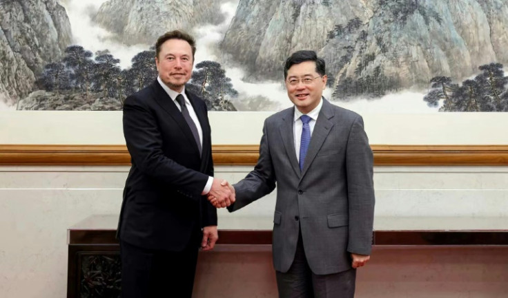 This handout picture taken and released by the Ministry of Foreign Affairs of the People's Republic of China on May 30, 2023 shows Tesla CEO Elon Musk (L) shaking hands with China's Foreign Minister Qin Gang during a meeting in Beijing. Elon Musk met Fore