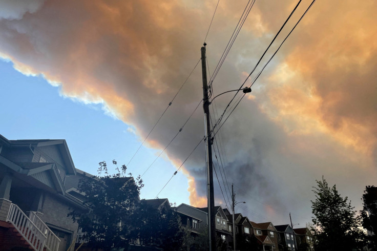 Smoke from the Tantallon wildfire rises over houses in nearby Bedford