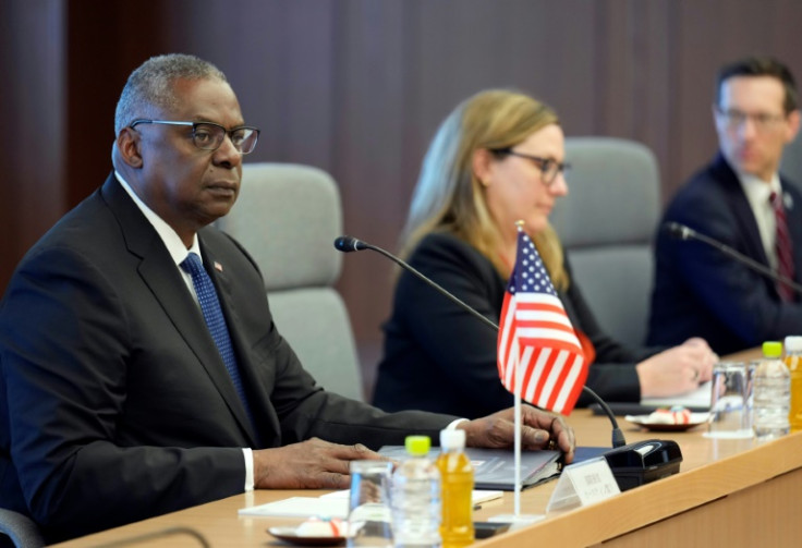 US Secretary of Defense Lloyd Austin (L) delivers an opening address at his meeting with his Japanese counterpart Yasukazu Hamada