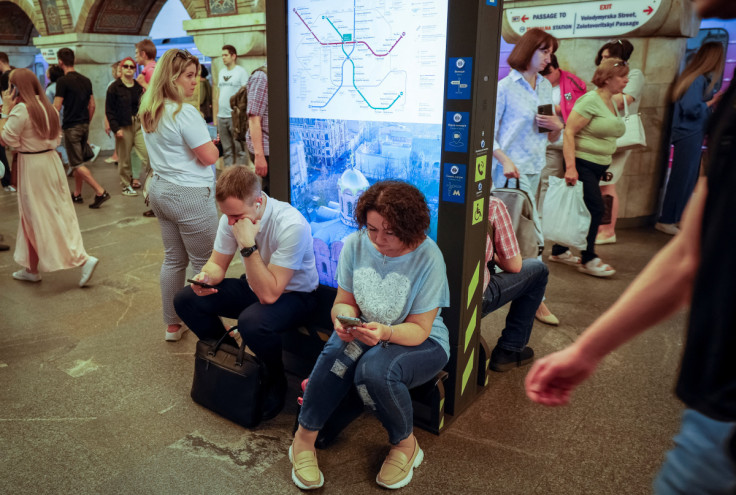 People take cover inside a subway station during an air raid alert in Kyiv