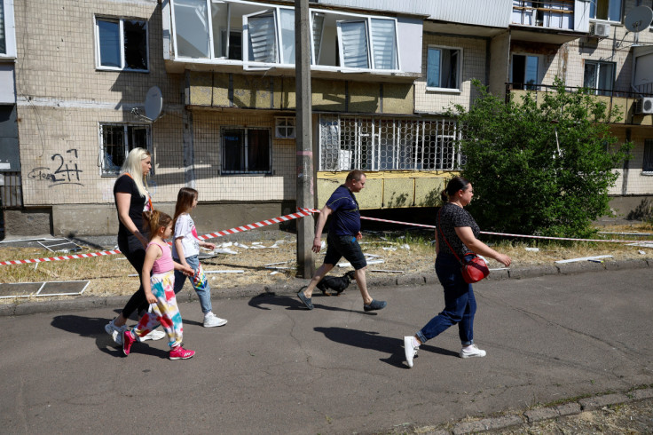 People run to a shelter during an air raid alert in Kyiv