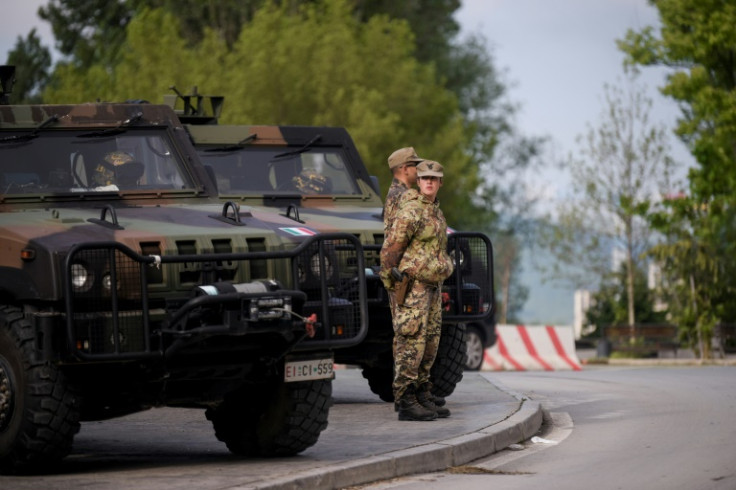 Police equipped with riot gear blocked the road leading to the bridge that separates the northern and southern parts of the city