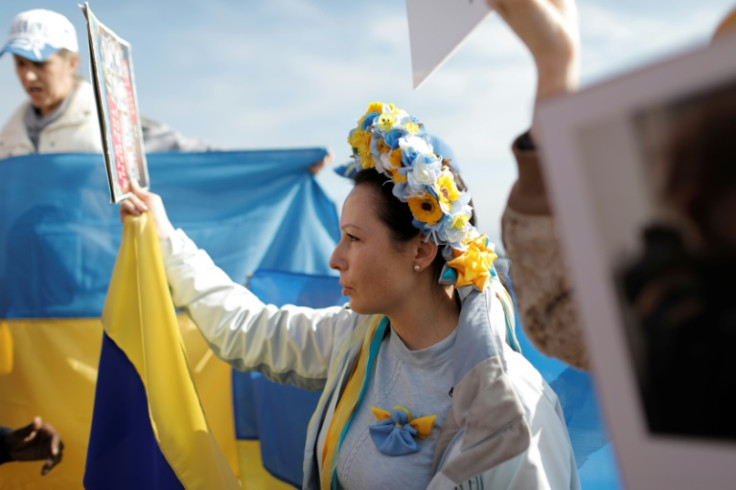 Protesters with Ukrainian flags and traditional clothes chanted 'Stop Putin! Stop the war!'