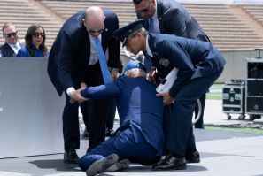 US President Joe Biden is helped up after falling during the graduation ceremony at the United States Air Force Academy