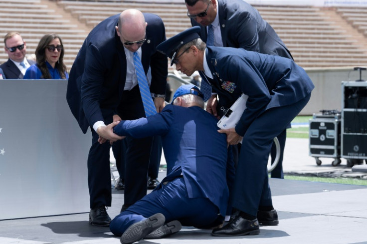 US President Joe Biden is helped up after falling during the graduation ceremony at the United States Air Force Academy