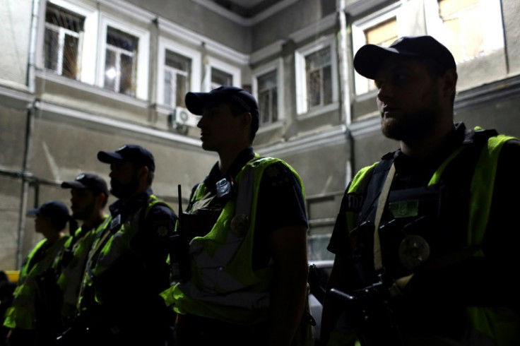 Ukrainian police officers attend a briefing prior to their night shift in Odesa