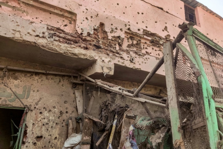Bullet holes riddle the wall of a building at Khartoum's Market Six where 18 civilians were killed in a bombardment by the regular army on Wednesday