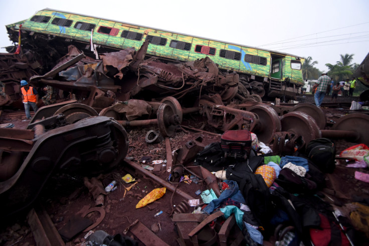 Belongings of passengers lie next to a damaged coach after a deadly collision of trains in Balasore