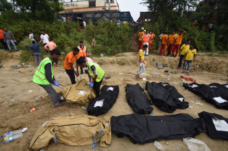 Rescue workers carry a body of a victim after a deadly collision of trains in Balasore