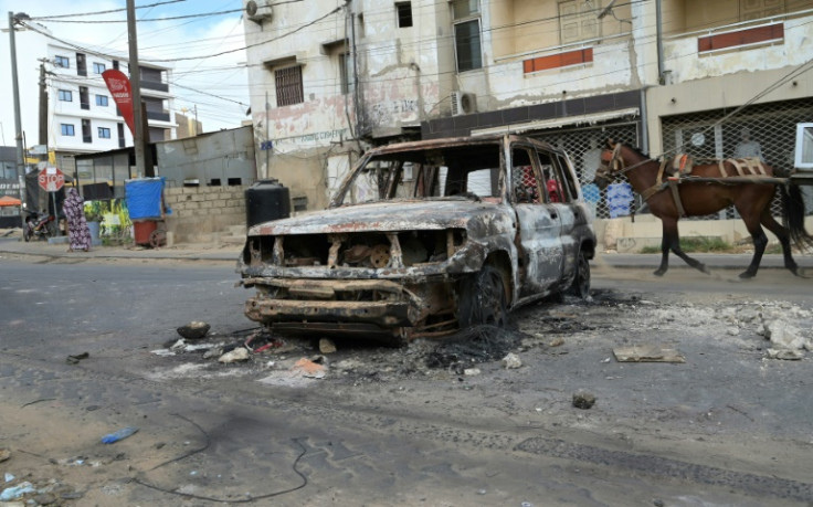 The remains of a vehicle after another night of violence in Dakar